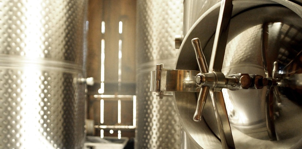 Wine is stored in steel tanks during fermentation before being bottled.